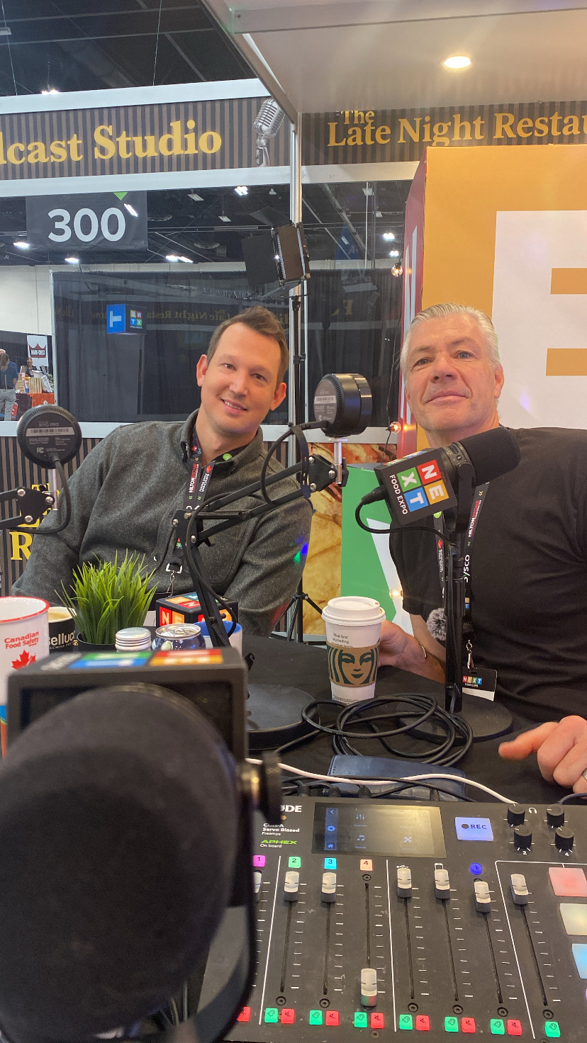 Two hosts recording at the The Late Night Restaurant Podcast studio booth
